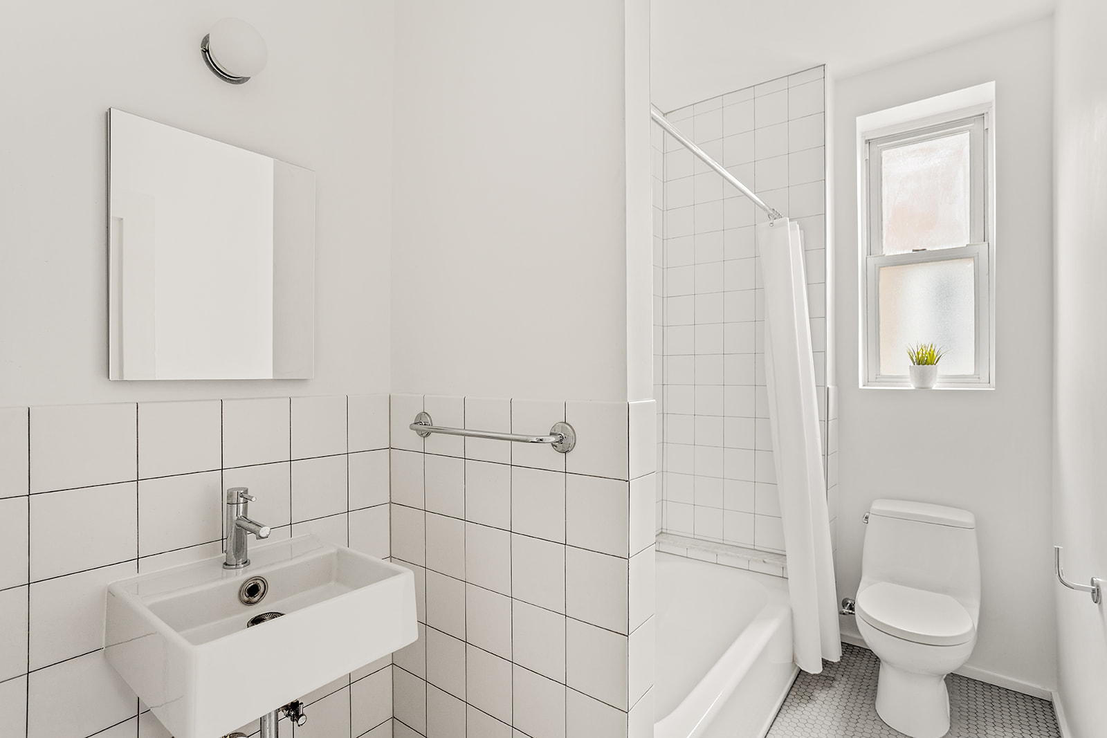 34-43 82nd Street, Unit 51 Queens, NY 11372 - Photo 7 of 12 a bathroom with a sink a toilet and shower