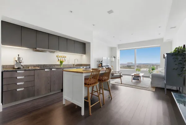 a kitchen with a table chairs and a refrigerator