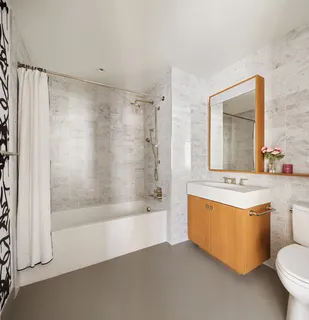 a bathroom with a sink mirror toilet and bathtub