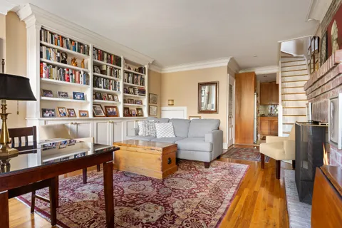 a living room with furniture and a book shelf