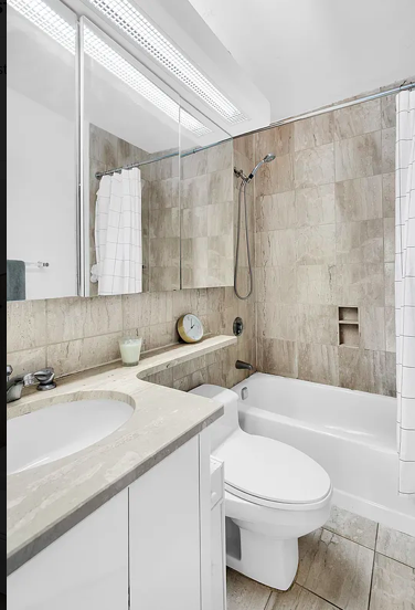 415 East 37th Street, Unit 22B Manhattan, NY 10016 - Photo 4 of 6 a bathroom with a sink a toilet and a bathtub