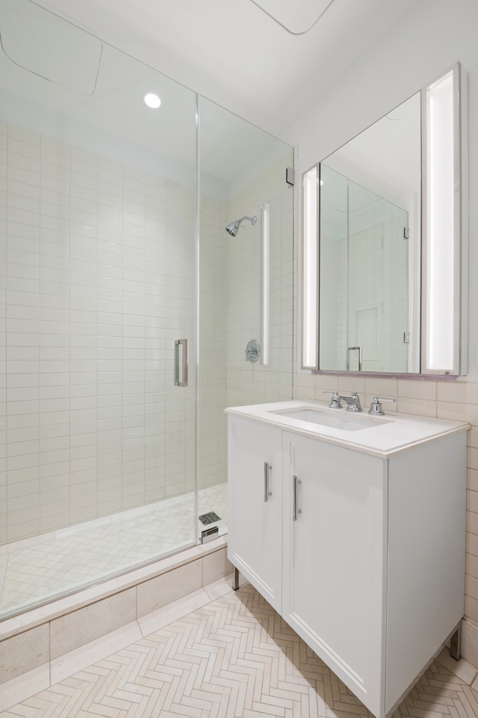 100 Barclay Street, Unit 21AD Manhattan, NY 10007 - Photo 21 of 40 a bathroom with a sink and a mirror with bathtub
