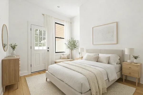 a bedroom with a large bed and a chandelier