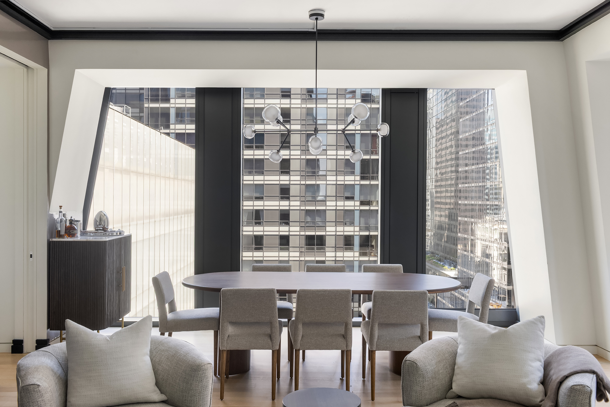 53 West 53rd Street, Unit 23D Manhattan, NY 10019 - Photo 2 of 11 a view of a dining room with furniture and windows