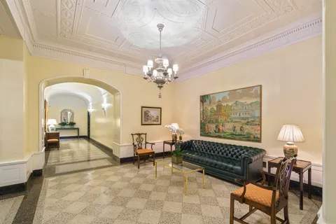 a living room with furniture and a chandelier