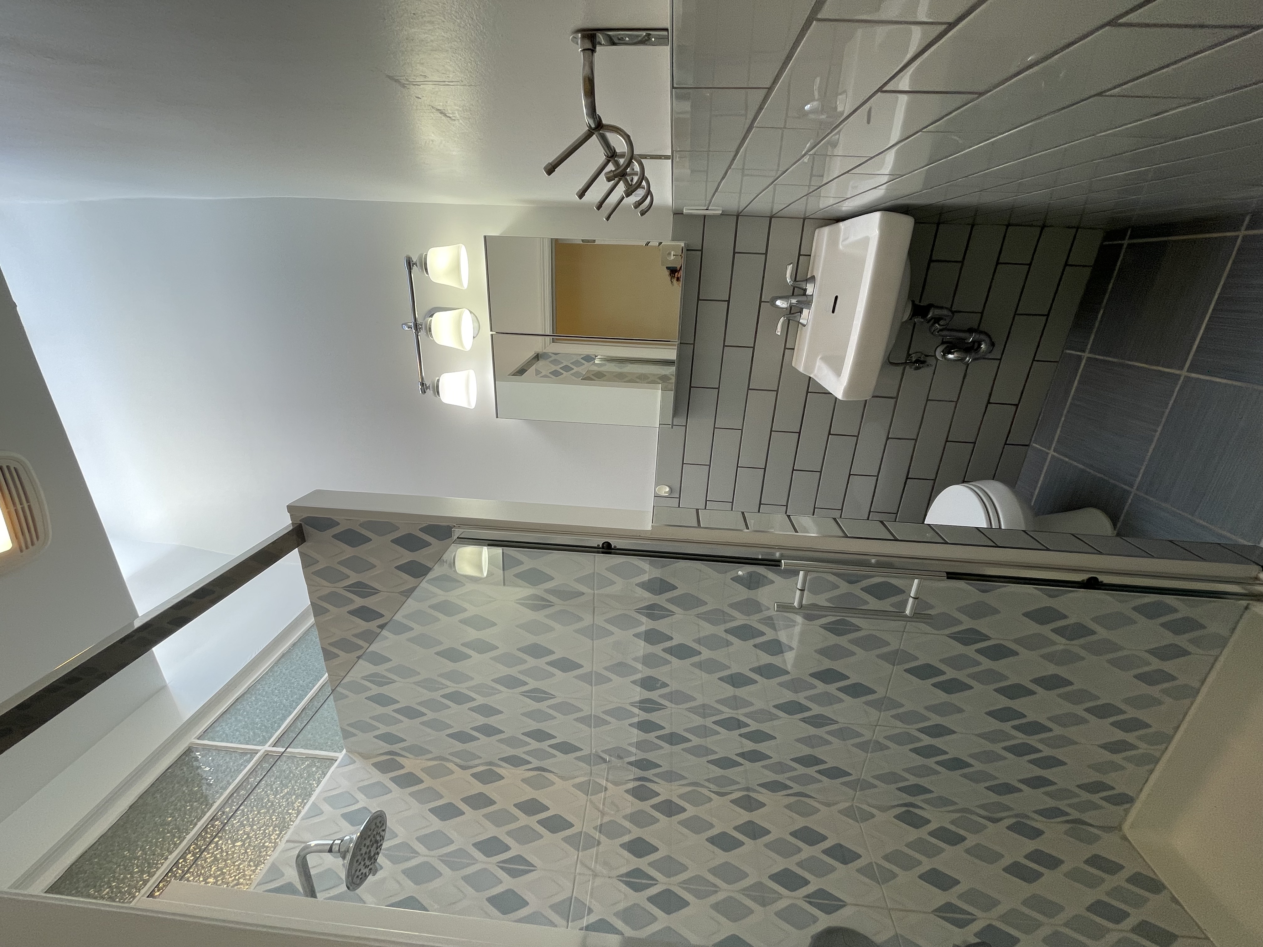 2446 Bedford Avenue, Unit 1 Brooklyn, NY 11226 - Photo 11 of 15 a bathroom with a sink toilet and shower