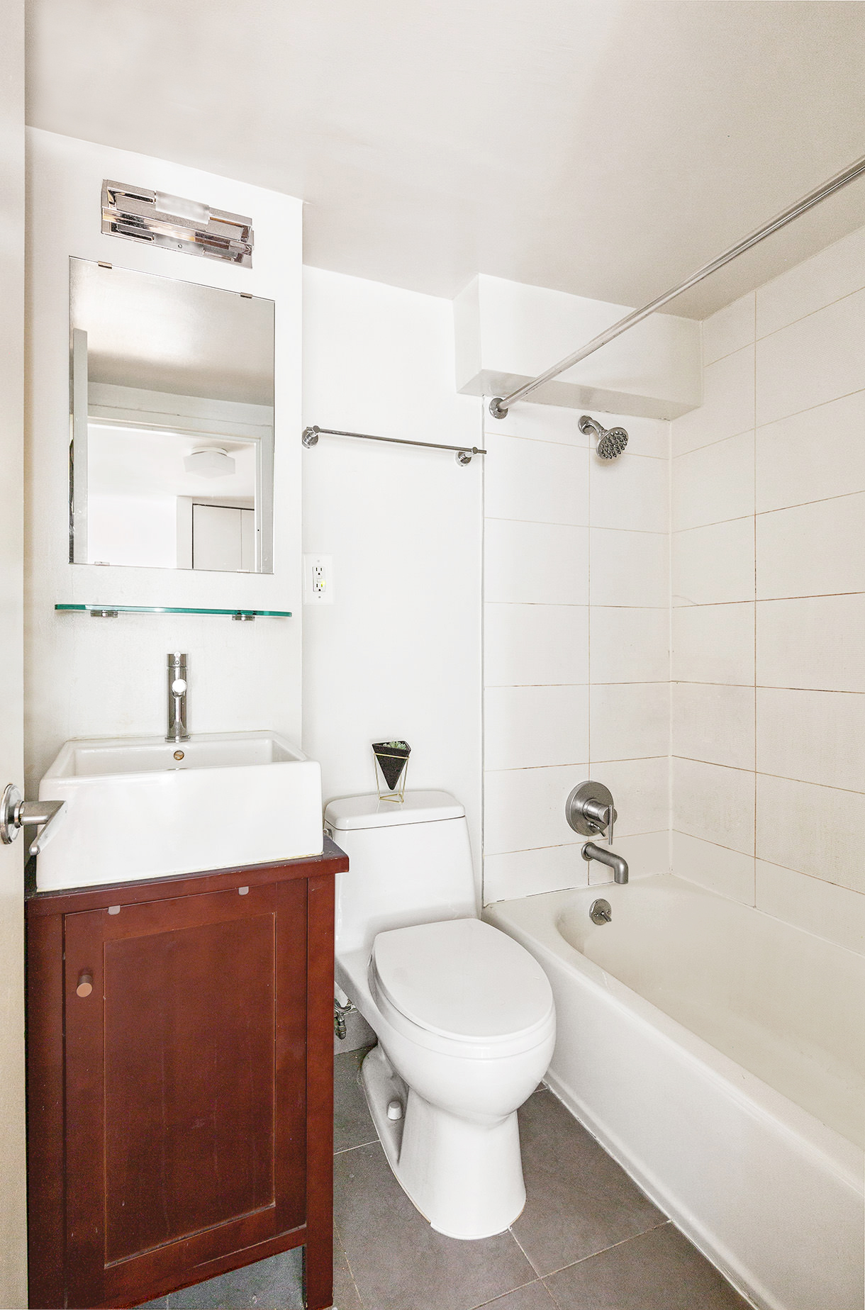 184 Thompson Street, Unit 2V Manhattan, NY 10012 - Photo 4 of 8 a bathroom with a sink a toilet and shower