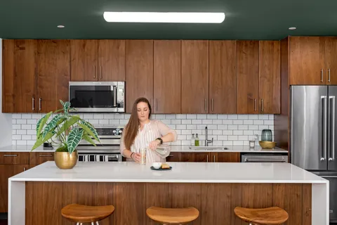 a kitchen with a sink a counter and a refrigerator