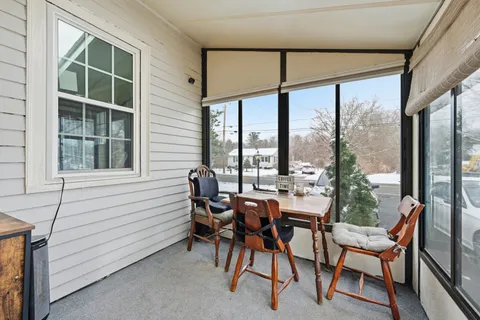 a view of a livingroom with furniture and floor to ceiling window