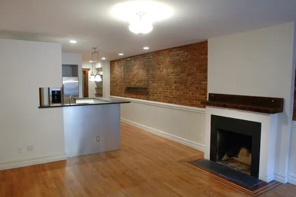 a view of a kitchen with a sink and a fireplace