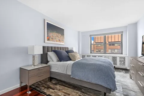 a bed room with a bed and a window