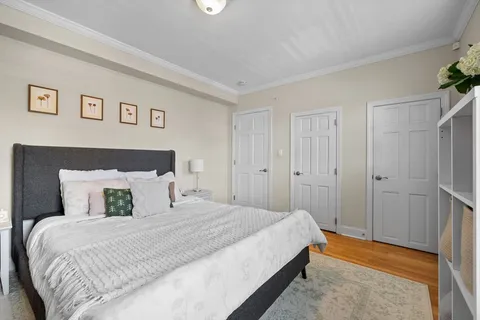 a bedroom with a bed and painting on the wall