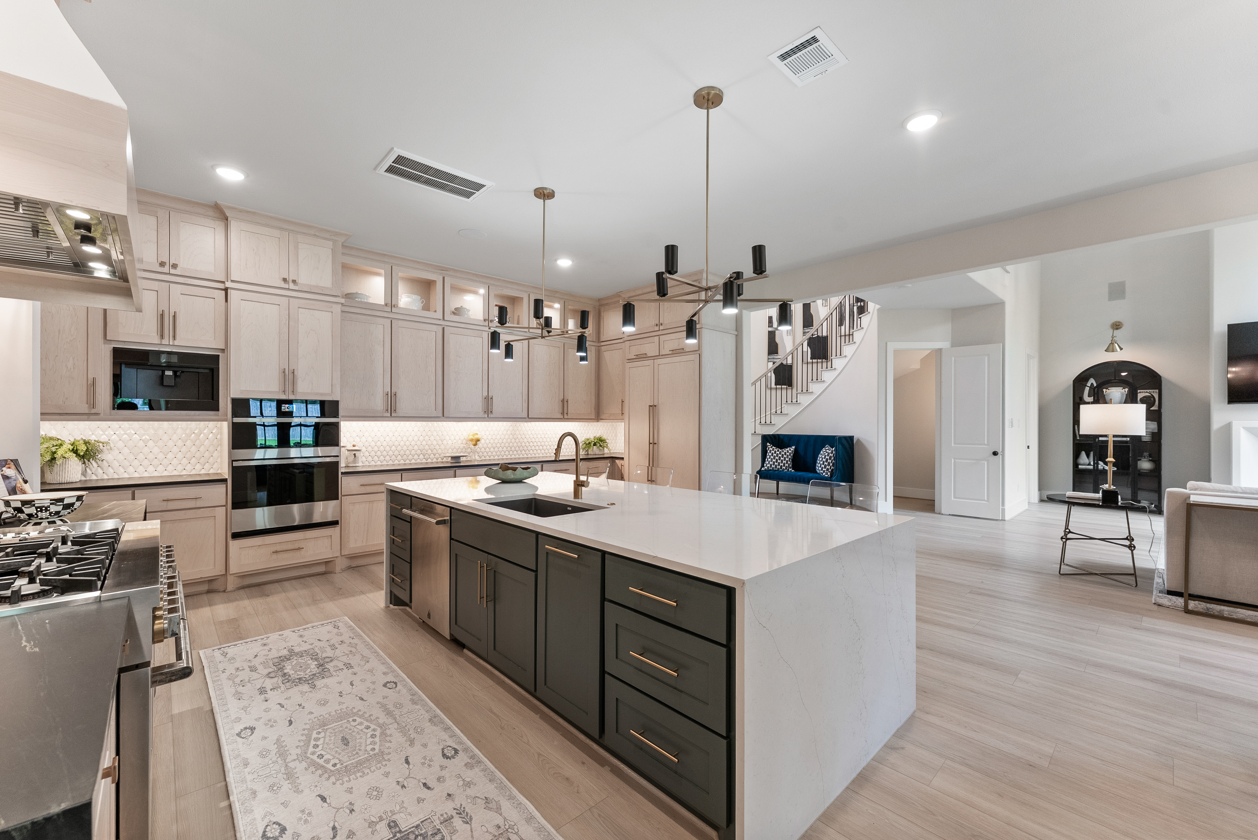 2118 Bennet Court Conroe, TX 77384 - Photo 18 of 70 a large kitchen with stainless steel appliances kitchen island granite countertop a sink a stove and a wooden floors