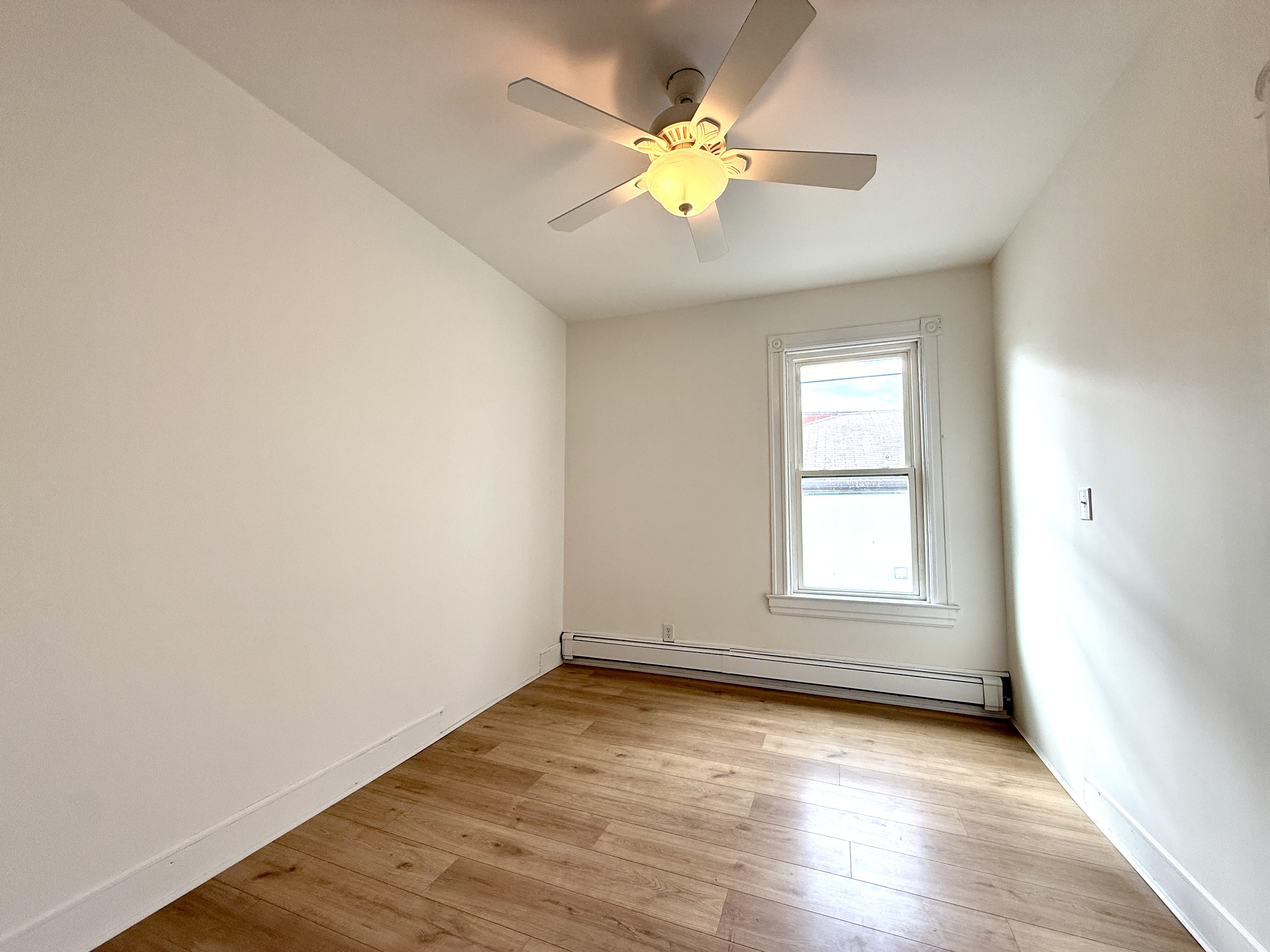31 Seeley Street, Unit Undisclosed Brooklyn, NY 11218 - Photo 14 of 31 an empty room with wooden floor and window
