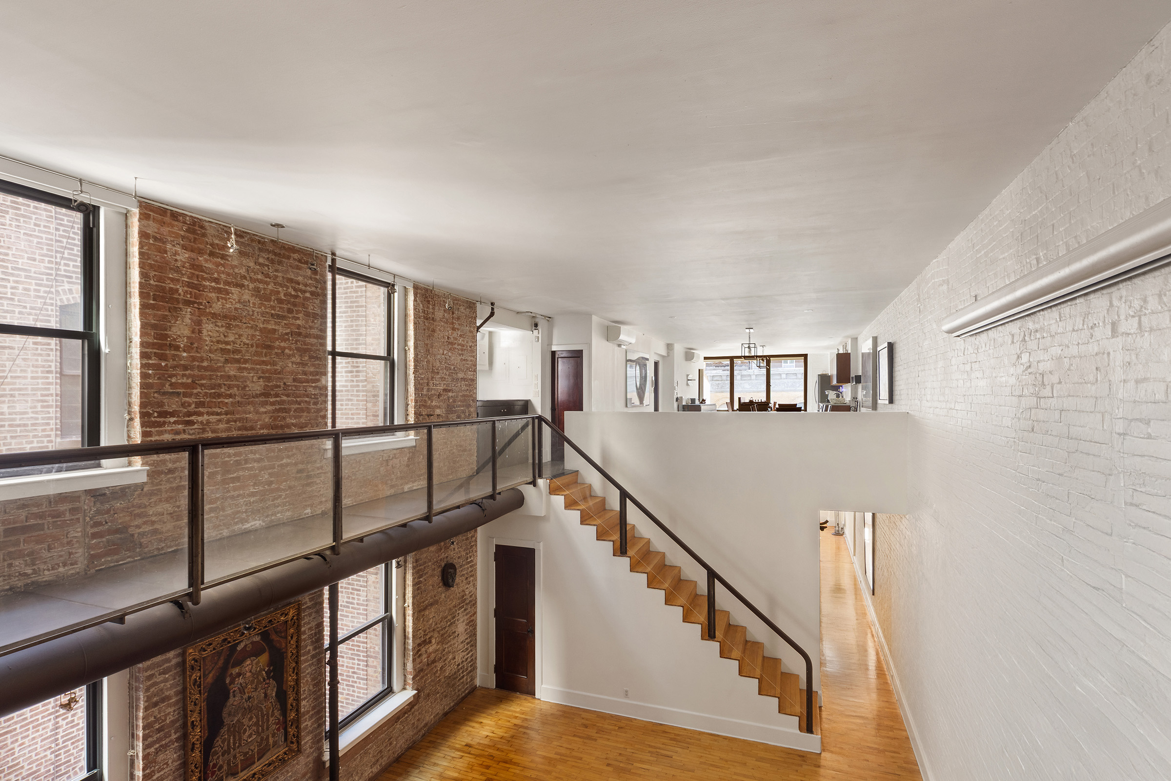 131 West 24th Street, Unit 5/6 Manhattan, NY 10011 - Photo 2 of 14 a view of staircase with lots of white walls and a window
