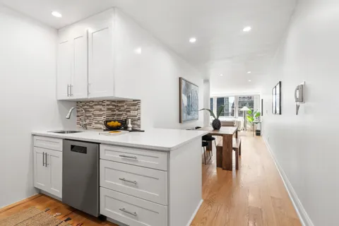 a kitchen with a table chairs stove and cabinets