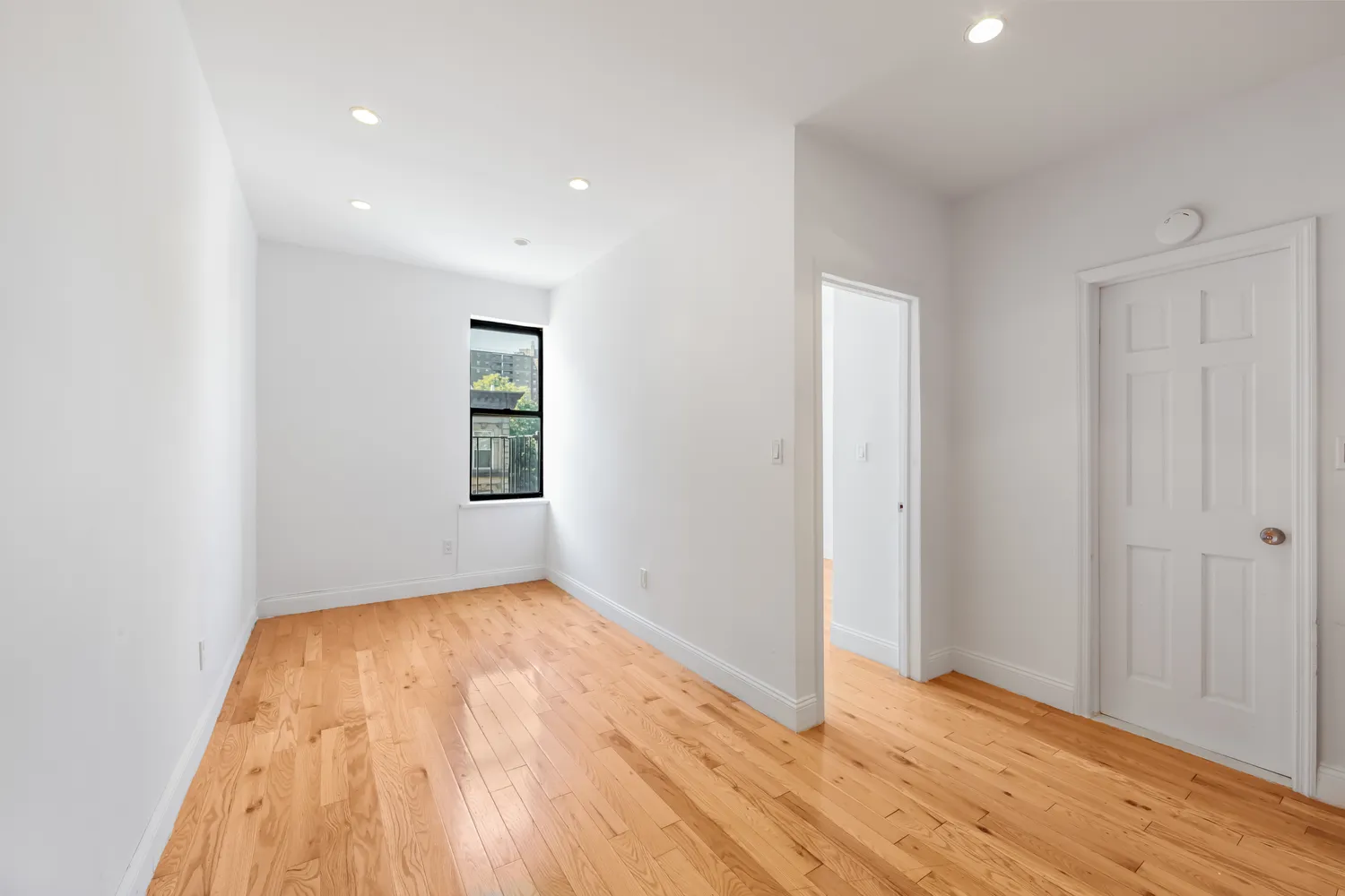 wooden floor in an empty room with a window