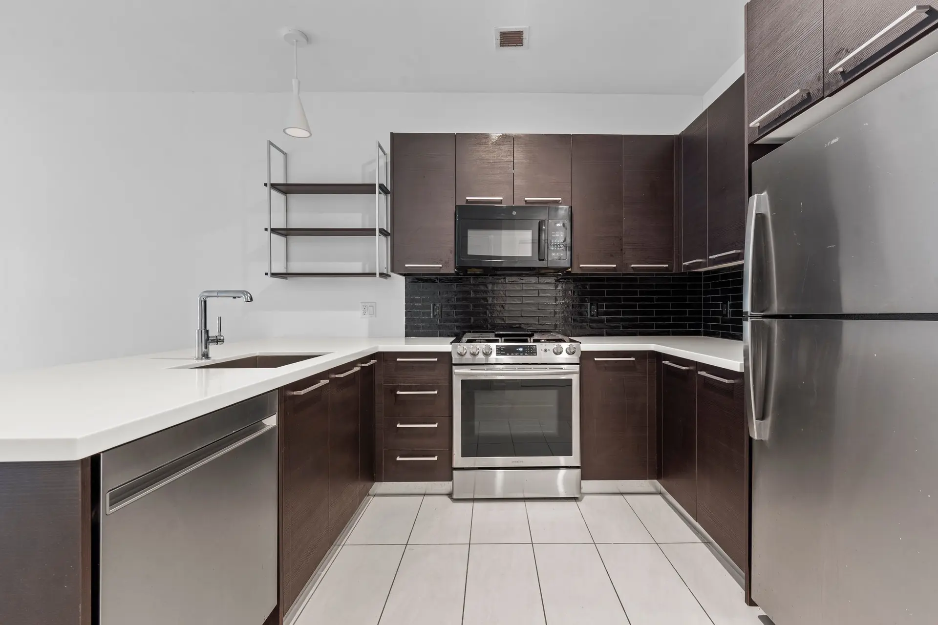 350 Clarkson Avenue, Unit 103 Brooklyn, NY 11226 - Photo 3 of 42 a kitchen with stainless steel appliances a stove a sink and a refrigerator