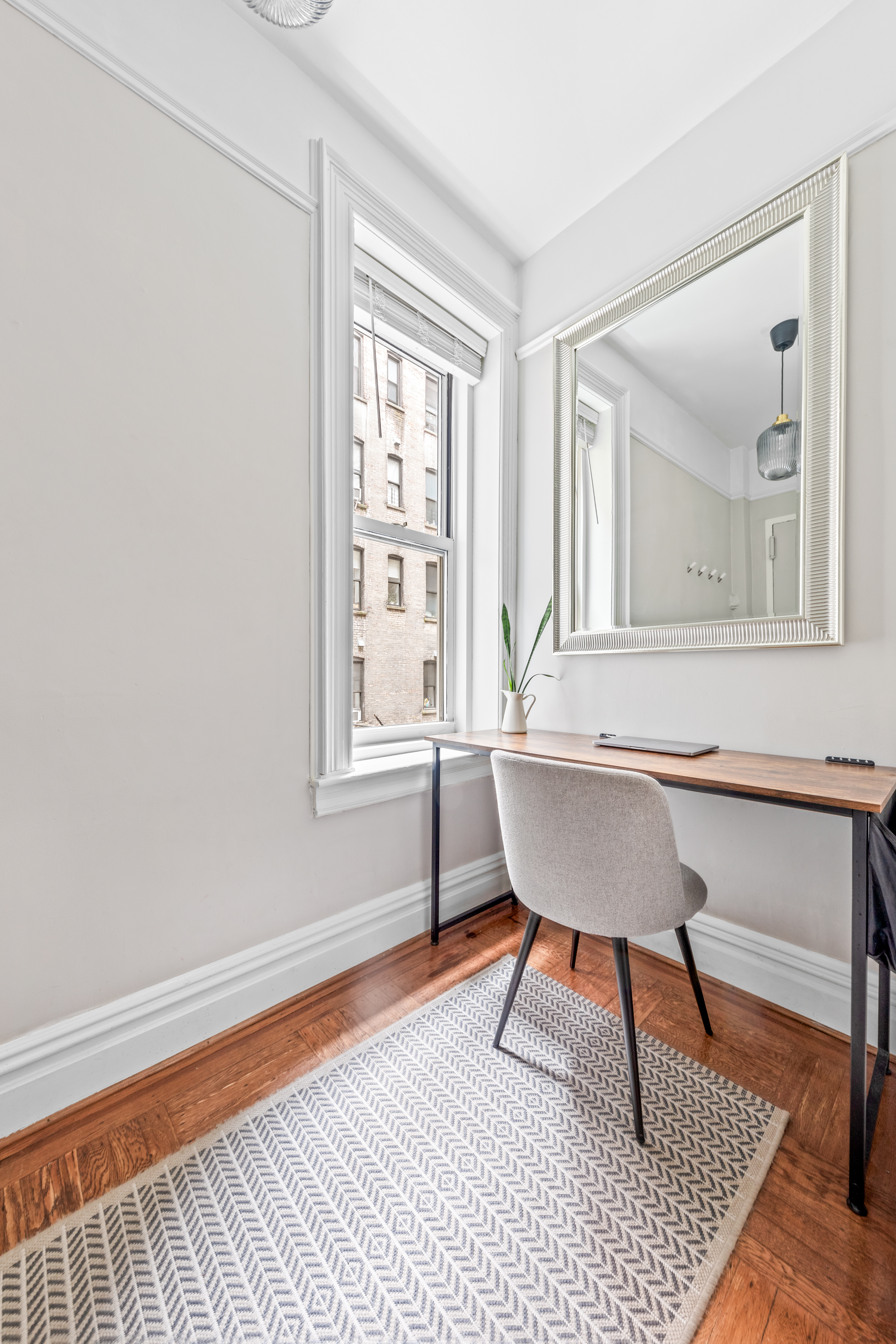 317 West 93rd Street, Unit 1C Manhattan, NY 10025 - Photo 7 of 9 a view of a room with a wooden floor and a window