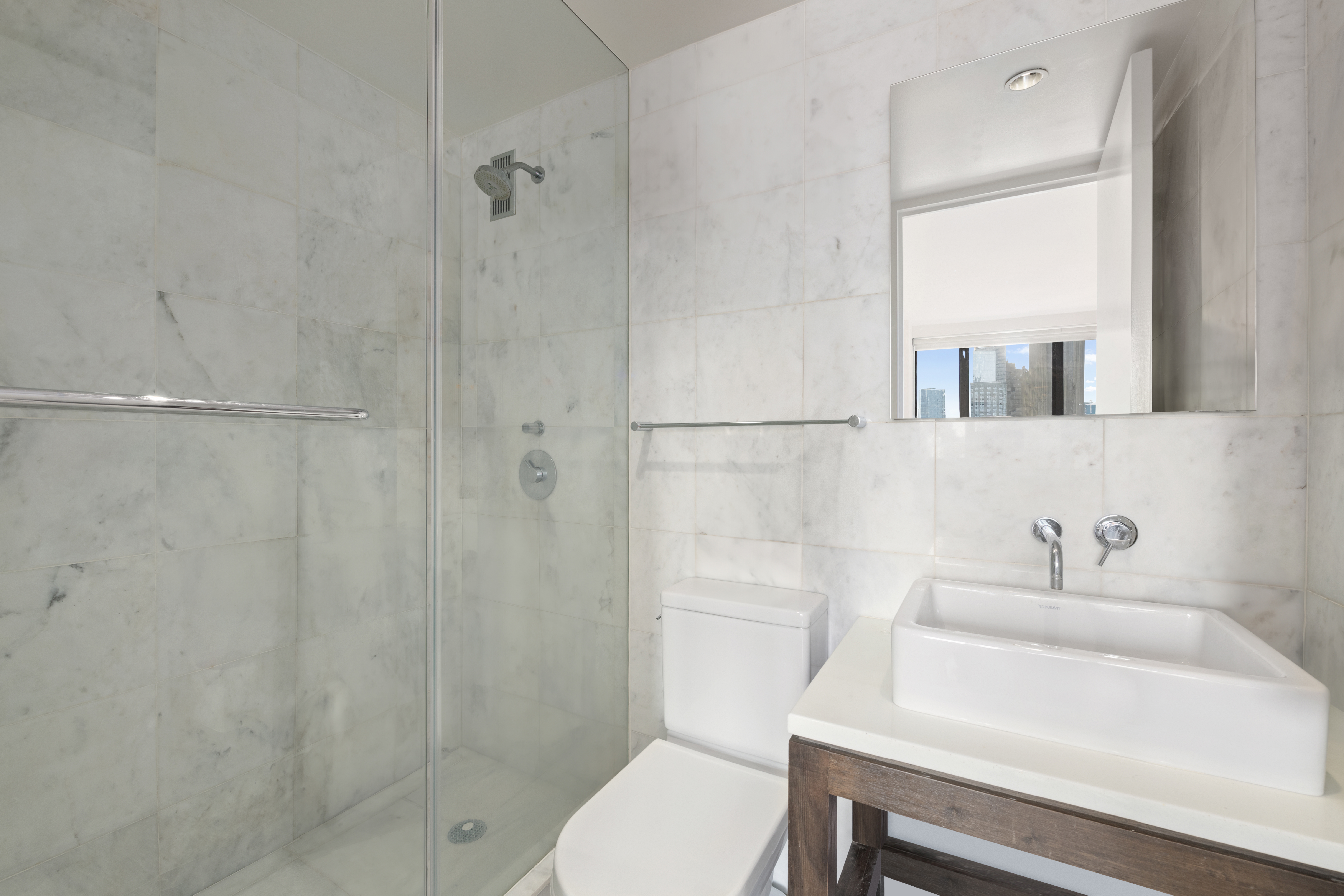 30 West 61st Street, Unit 9C Manhattan, NY 10023 - Photo 8 of 10 a bathroom with a sink toilet and shower