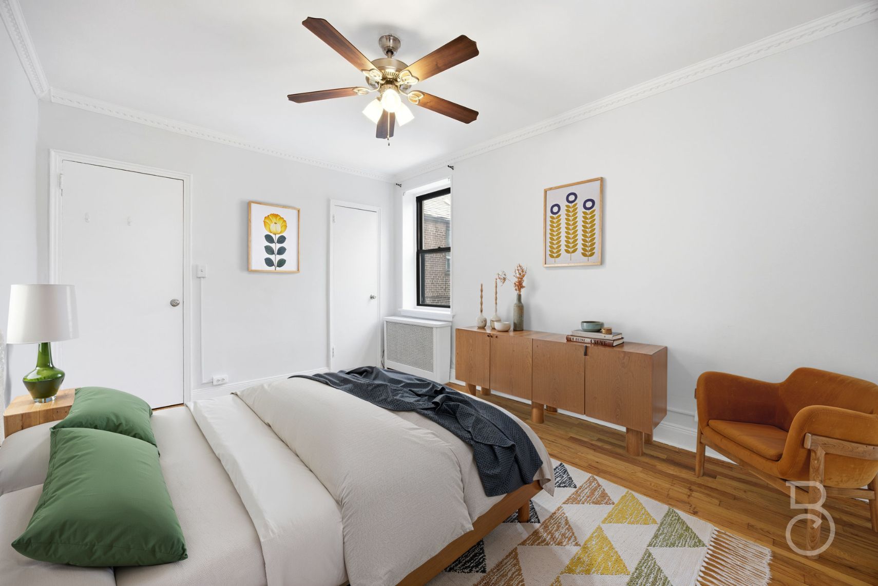 78-15 19th Drive, Unit B2 Queens, NY 11370 - Photo 8 of 17 a bedroom with a bed and a chandelier