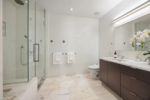 a bathroom with a toilet sink and shower