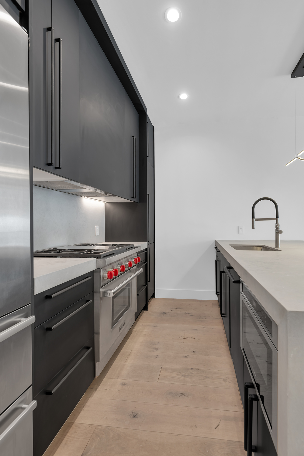38-26 29th Street, Unit 2 Queens, NY 11101 - Photo 3 of 14 a kitchen with stainless steel appliances granite countertop a sink and a stove