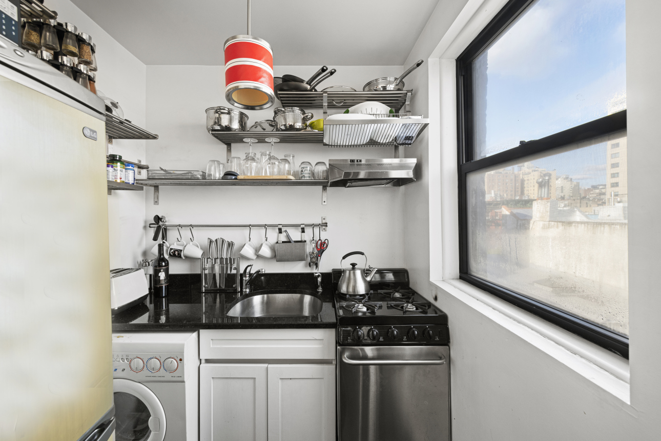 87 St Marks Place, Unit 4E Manhattan, NY 10009 - Photo 3 of 9 a kitchen with stainless steel appliances granite countertop a sink and cabinets