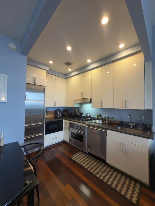 a kitchen with stainless steel appliances granite countertop a stove and a refrigerator