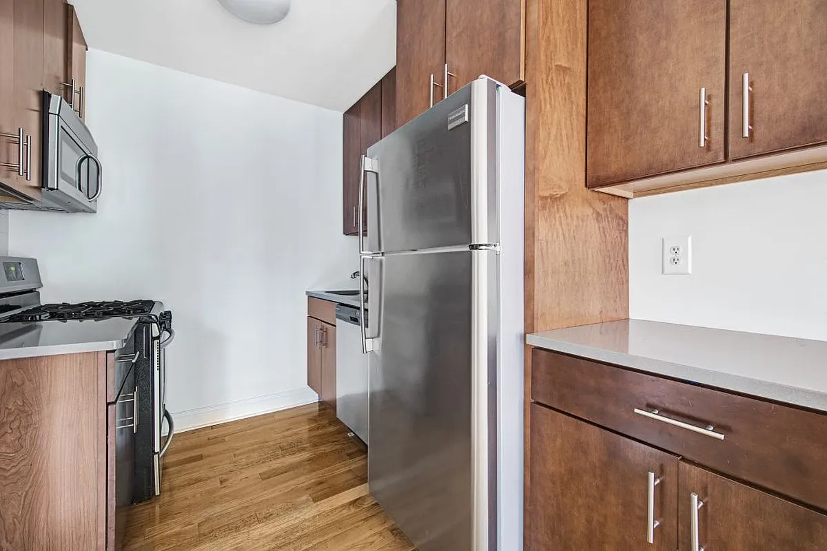 138 Baltic Street, Unit 3C Brooklyn, NY 11201 - Photo 3 of 10 a kitchen with a refrigerator and cabinets