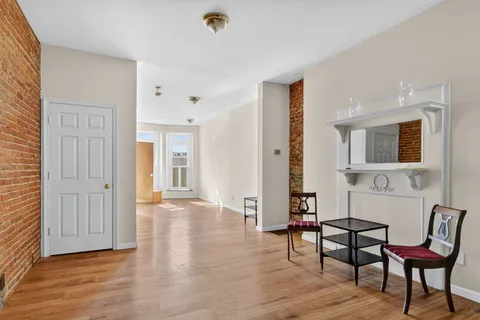 a view of a room with furniture and wooden floor