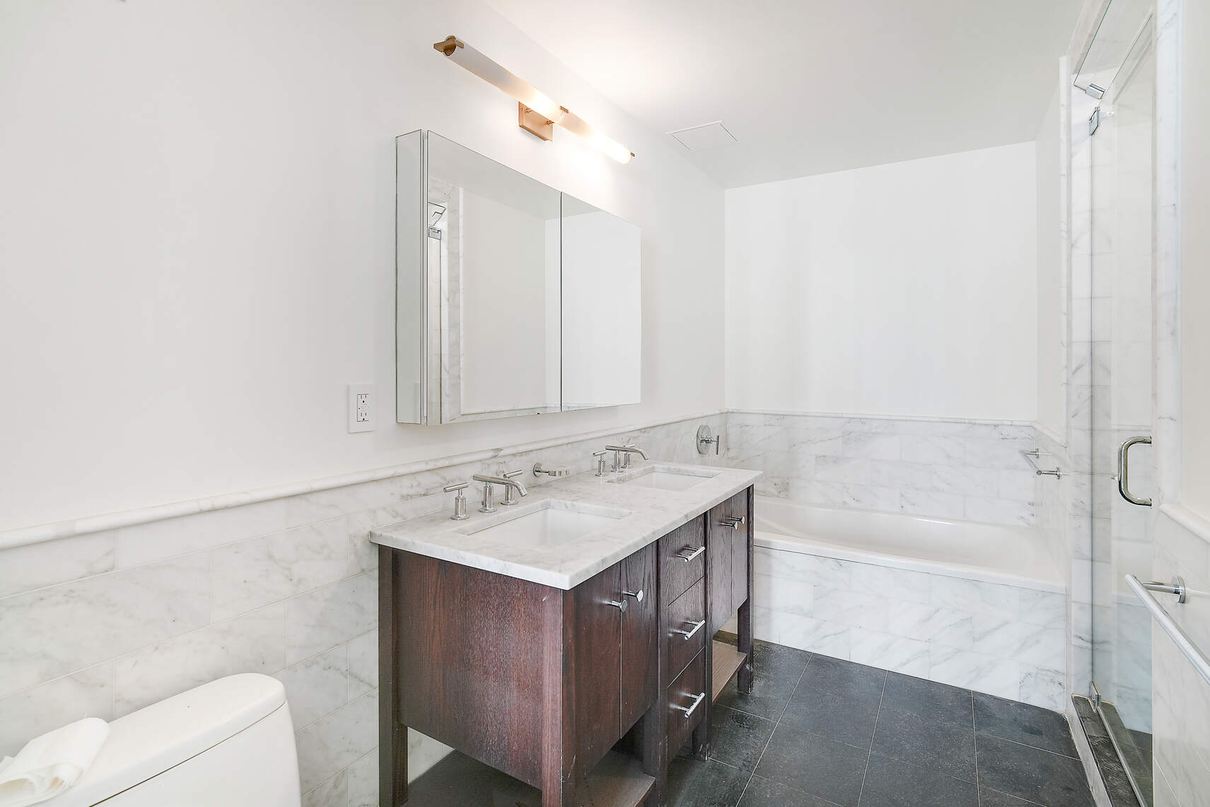 454 West 54th Street, Unit 3A Manhattan, NY 10019 - Photo 12 of 13 a bathroom with a sink and a mirror