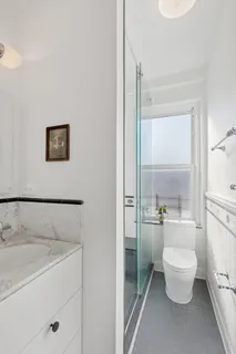 a bathroom with a toilet sink and a shower