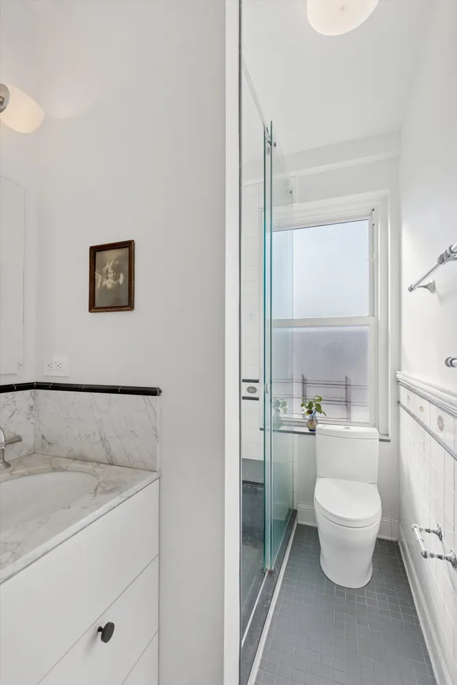 a bathroom with a toilet sink and a shower