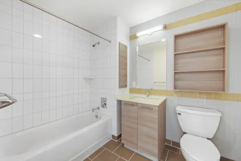 a bathroom with a granite countertop toilet a sink and bathtub