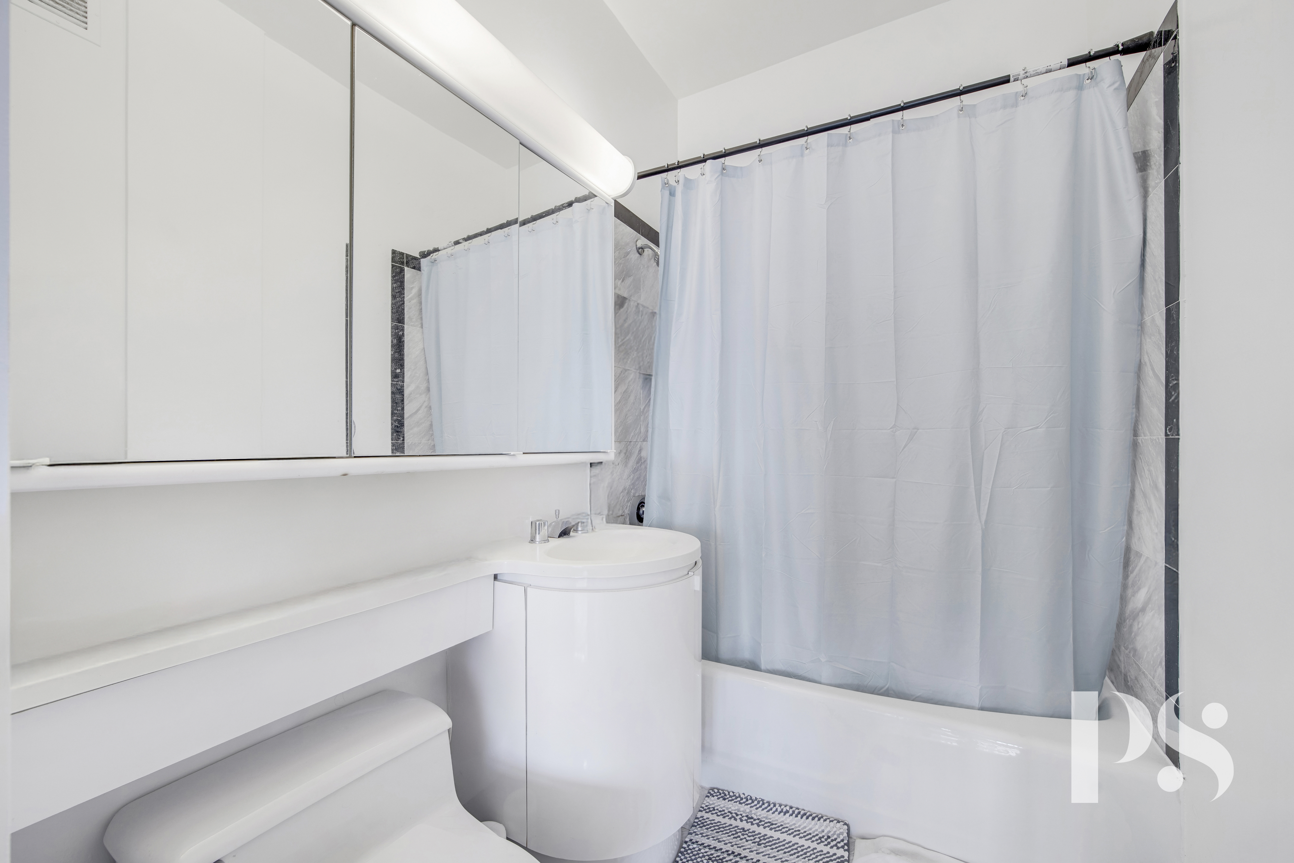 200 East 32nd Street, Unit 33C Manhattan, NY 10016 - Photo 11 of 12 a bathroom with a sink a toilet and shower