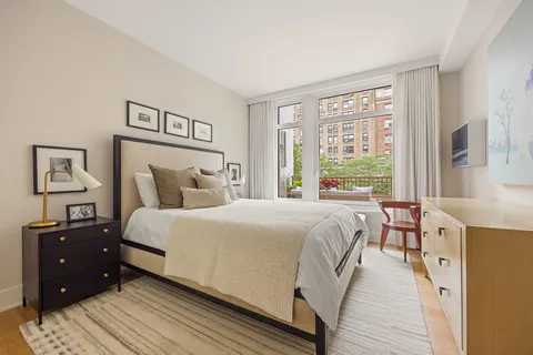 a bedroom with a bed and a night stand