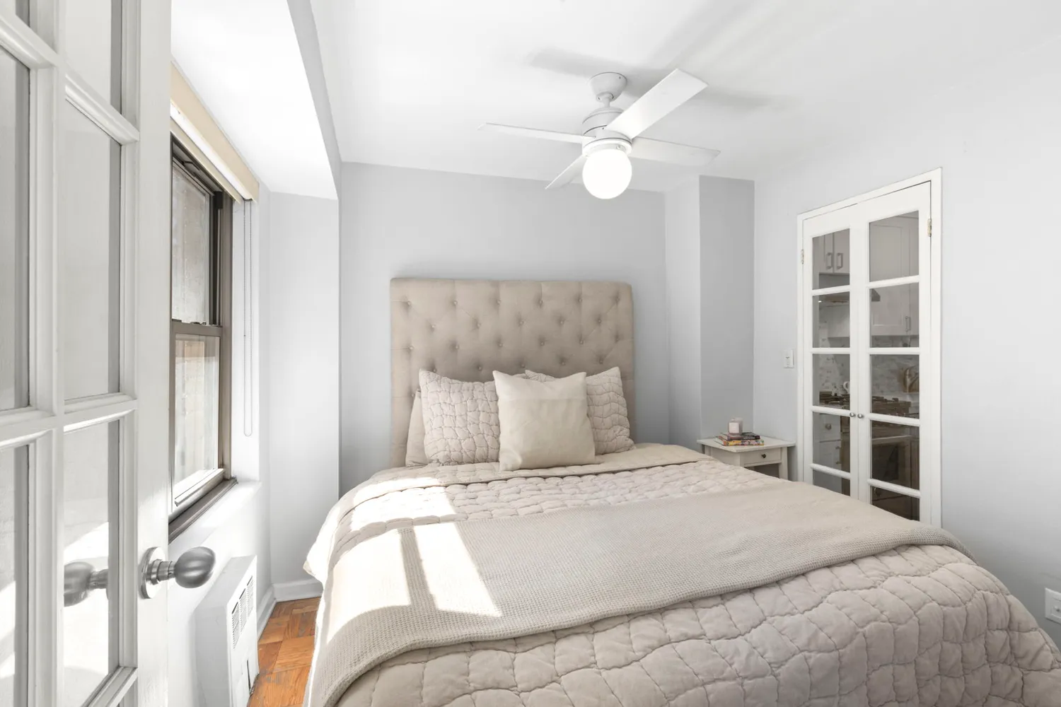 a bedroom with a bed and a window