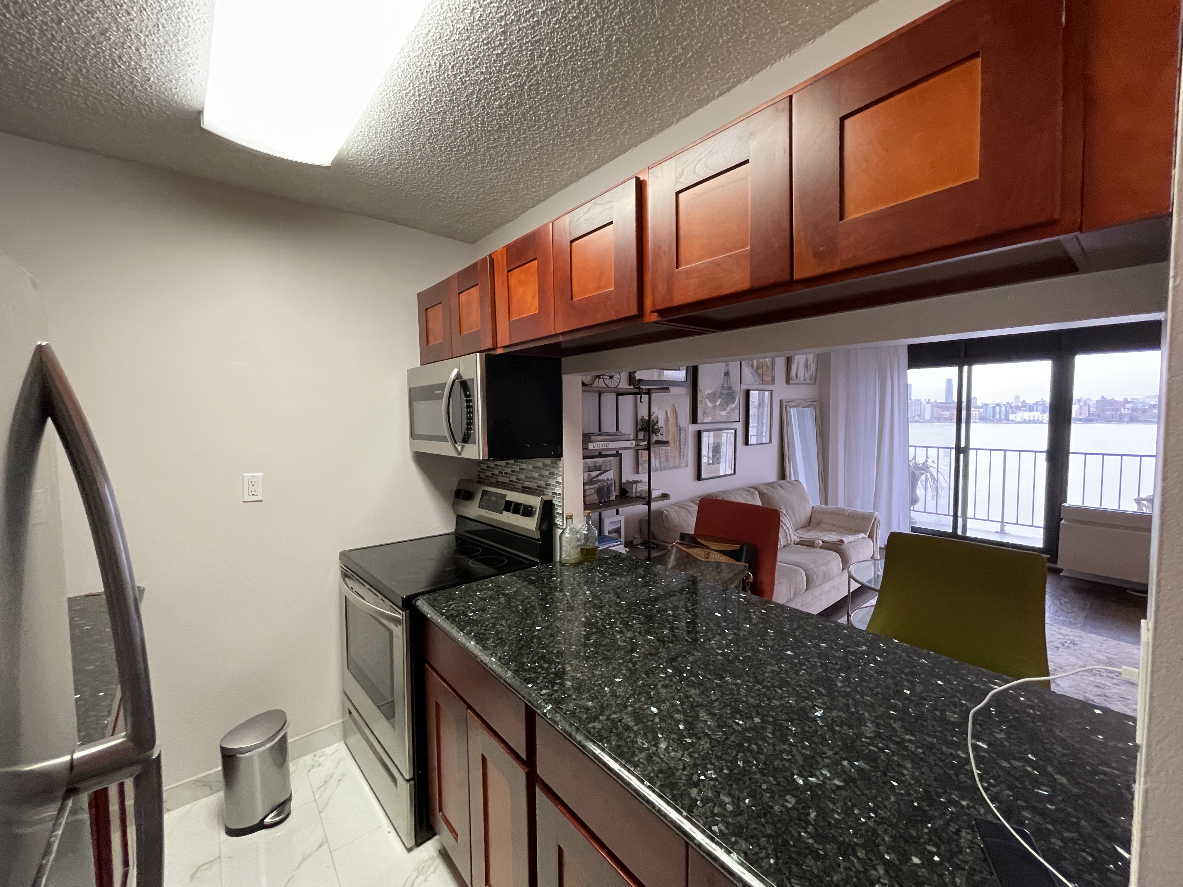25-40 Shore Boulevard, Unit 8T Queens, NY 11102 - Photo 9 of 23 a kitchen with granite countertop lots of counter top space