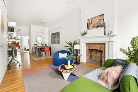 a living room with furniture fireplace and a table
