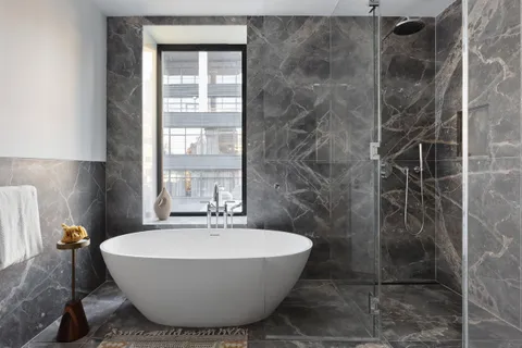 a bathroom with a bathtub and shower