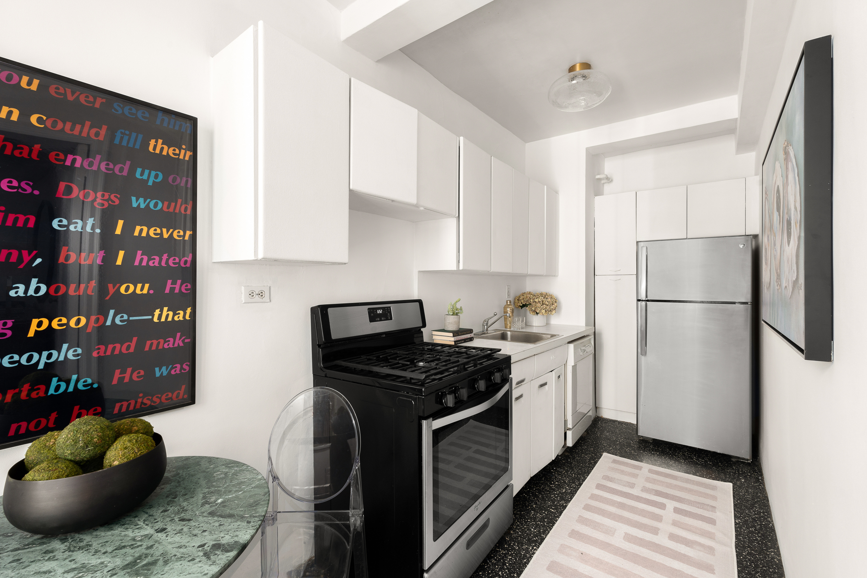 465 West 23rd Street, Unit 10A Manhattan, NY 10011 - Photo 4 of 12 a kitchen with stainless steel appliances granite countertop a sink stove and refrigerator