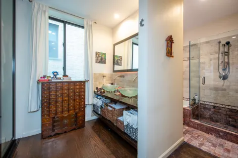 a view of walk in closet and bathroom