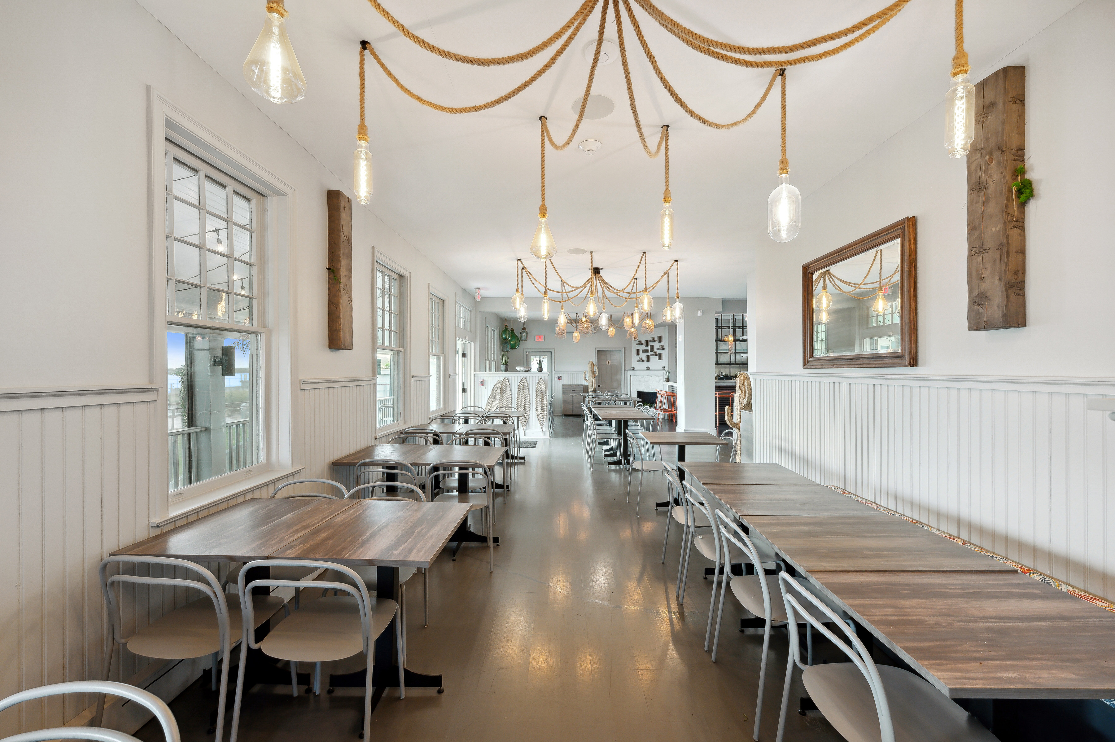 32 Lighthouse Road Hampton Bays, NY 11946 - Photo 20 of 51 a view of a dining room with furniture a chandelier and wooden floor