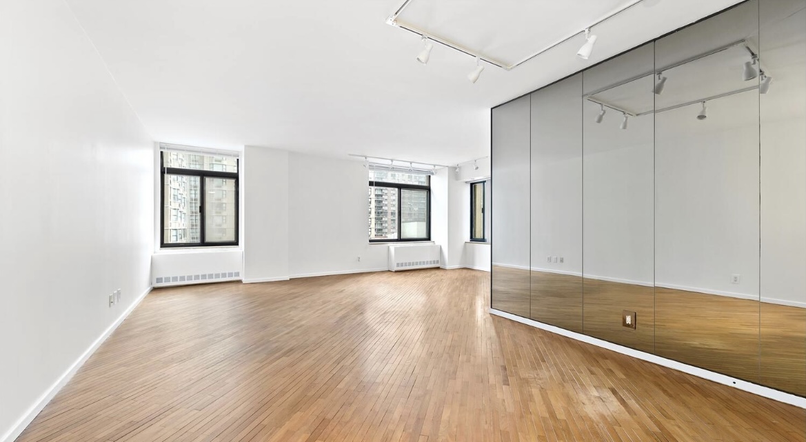 400 East 70th Street, Unit 807 Manhattan, NY 10021 - Photo 1 of 9 a view of an empty room with window and wooden floor