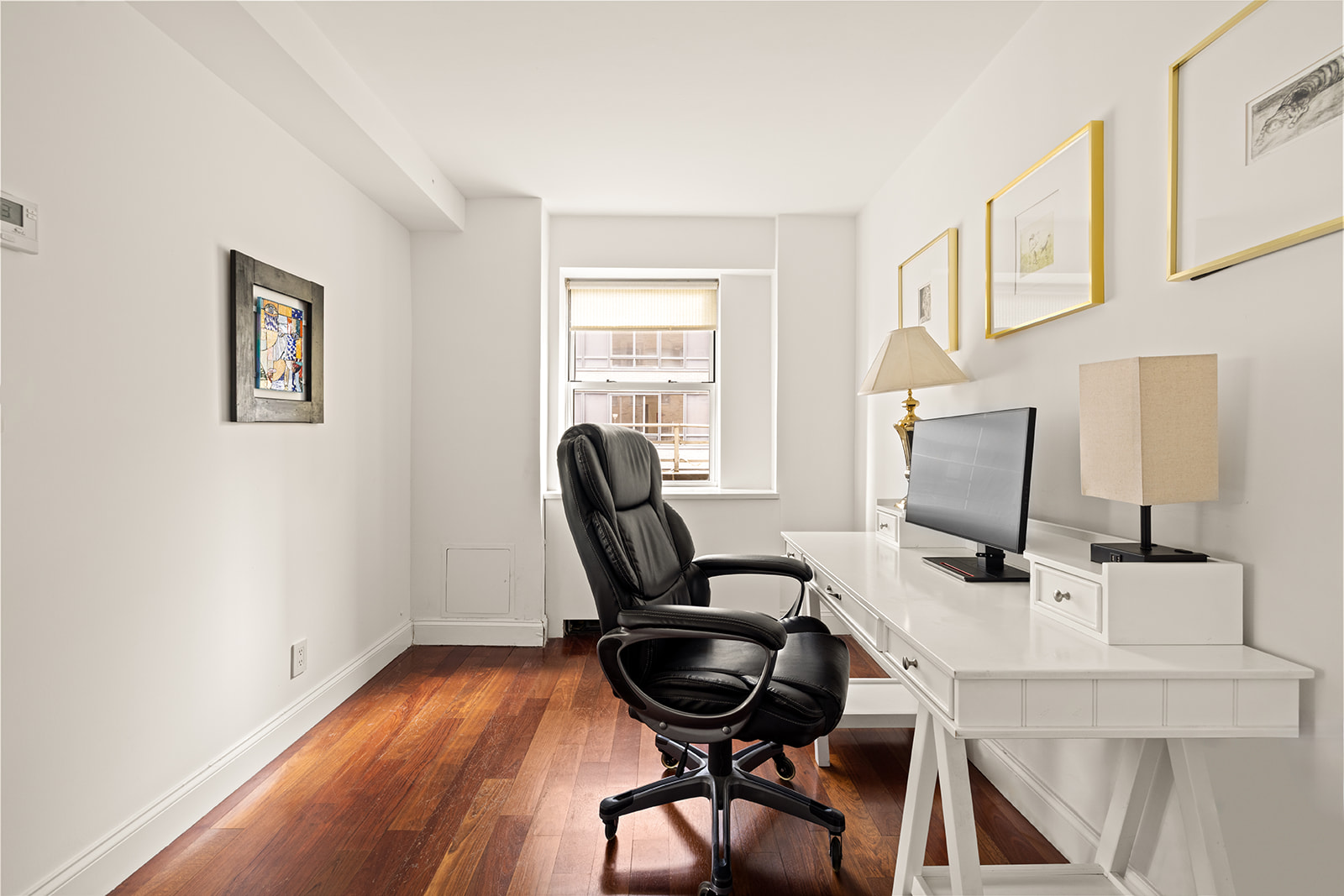 330 East 49th Street, Unit 12E Manhattan, NY 10017 - Photo 11 of 16 a view of a workspace with furniture and a window
