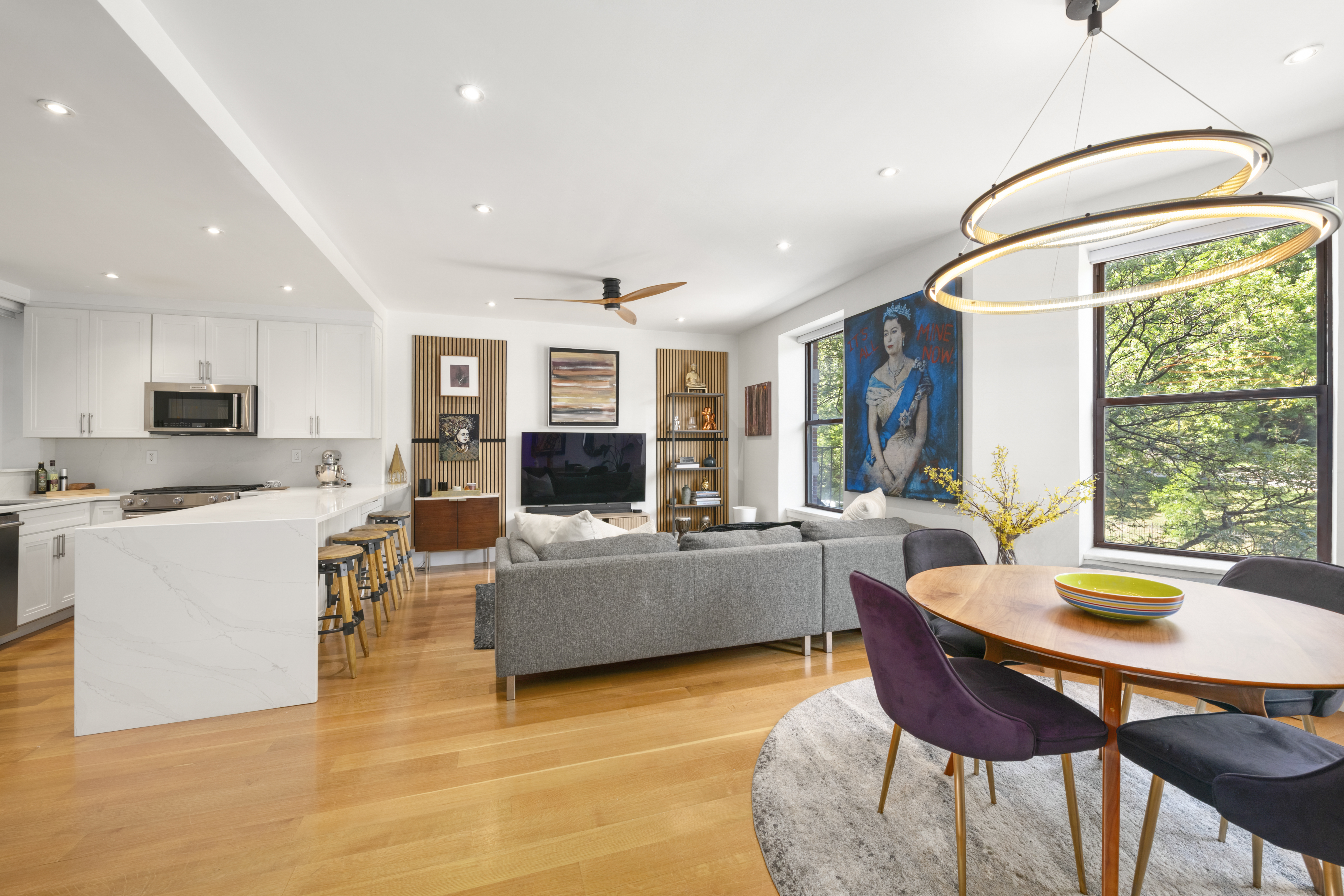 364 West 121st Street, Unit 2A Manhattan, NY 10027 - Photo 2 of 13 a living room with furniture a flat screen tv and a large window