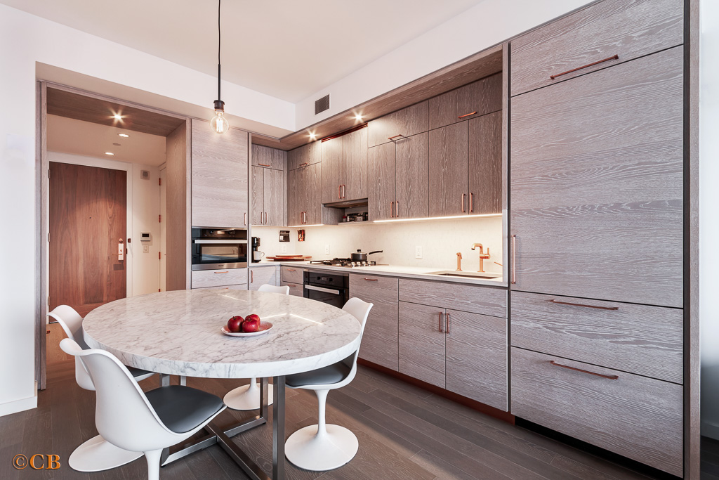 1 City Point, Unit 50B Brooklyn, NY 11201 - Photo 5 of 29 a kitchen with a table chairs sink and cabinets