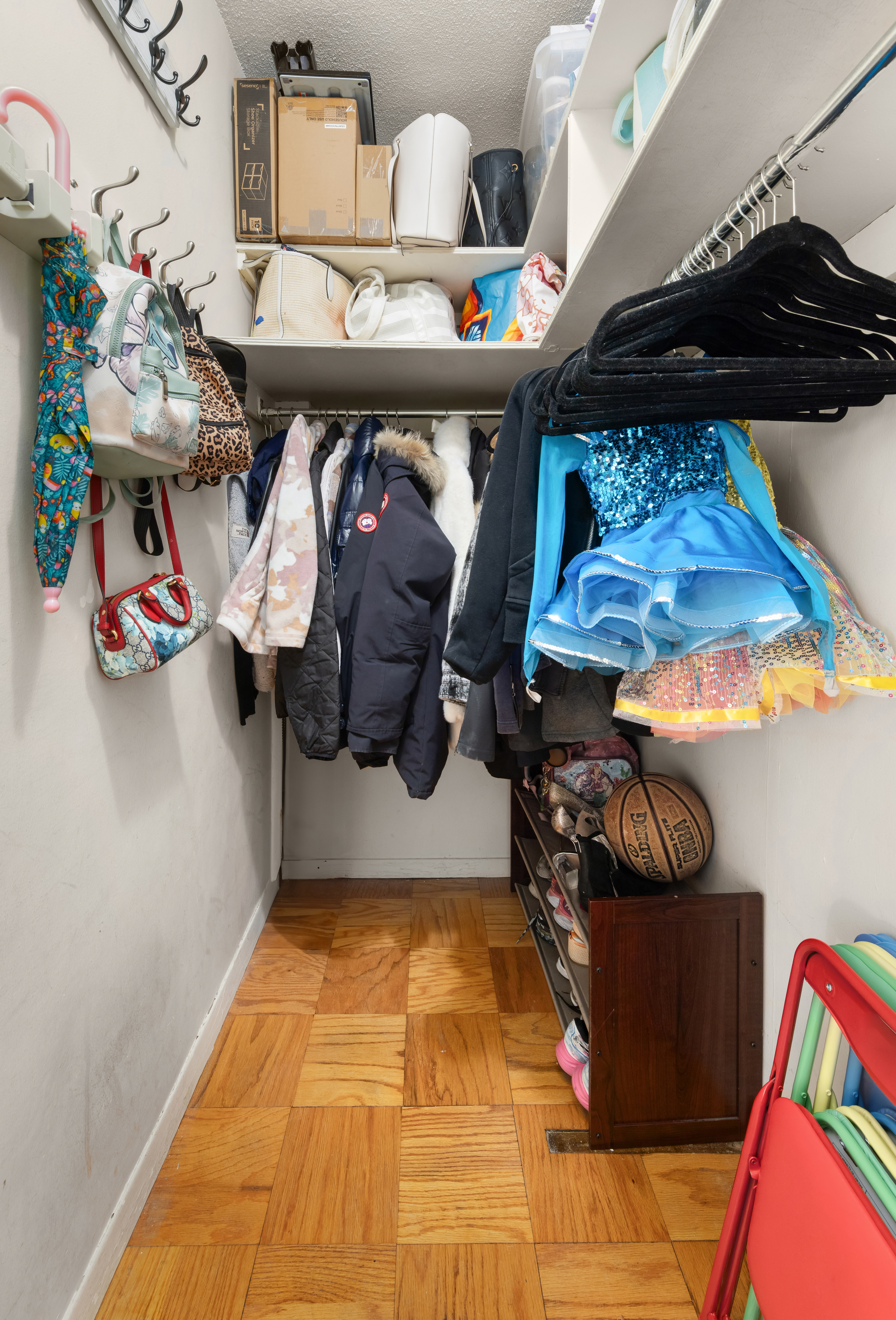 70-31 108th Street, Unit 12D Queens, NY 11375 - Photo 10 of 16 a room with lots of different colored cloths