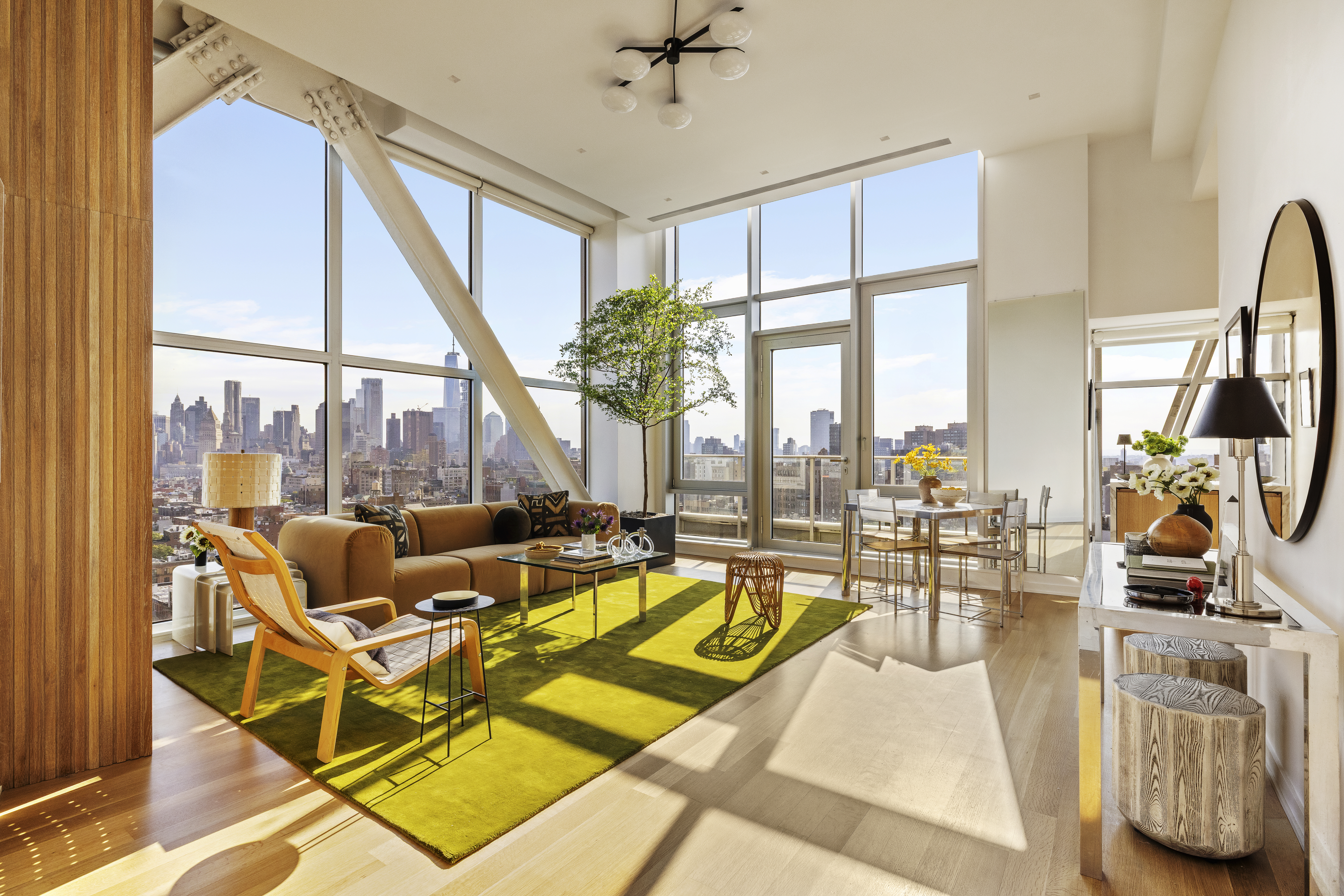 52 East 4th Street, Unit PH3 Manhattan, NY 10003 - Photo 3 of 22 a living room with furniture a floor to ceiling windows and floor to ceiling windows